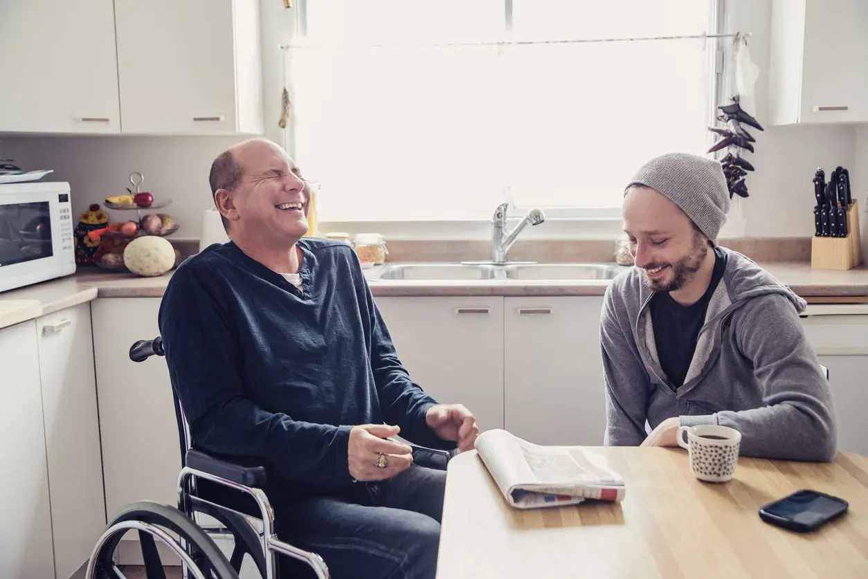 ndis-mental-health-support-worker-home-support-sa NDIS Mental Health Support Worker sharing a lighthearted moment with participant at home