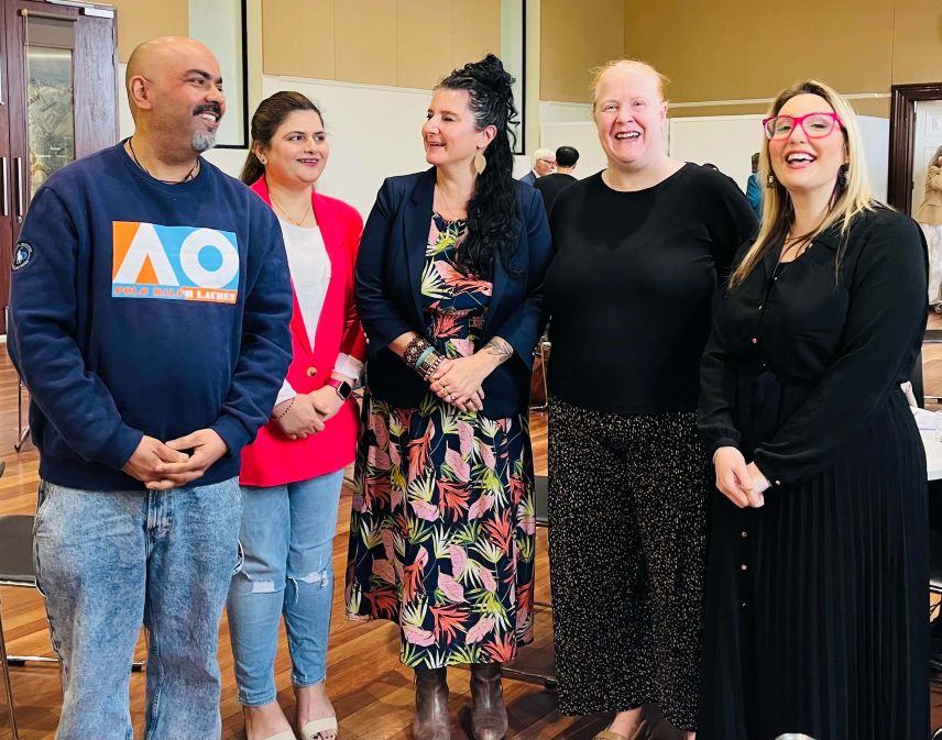 A group of five attendees smiling together at the MHCSA Annual AGM