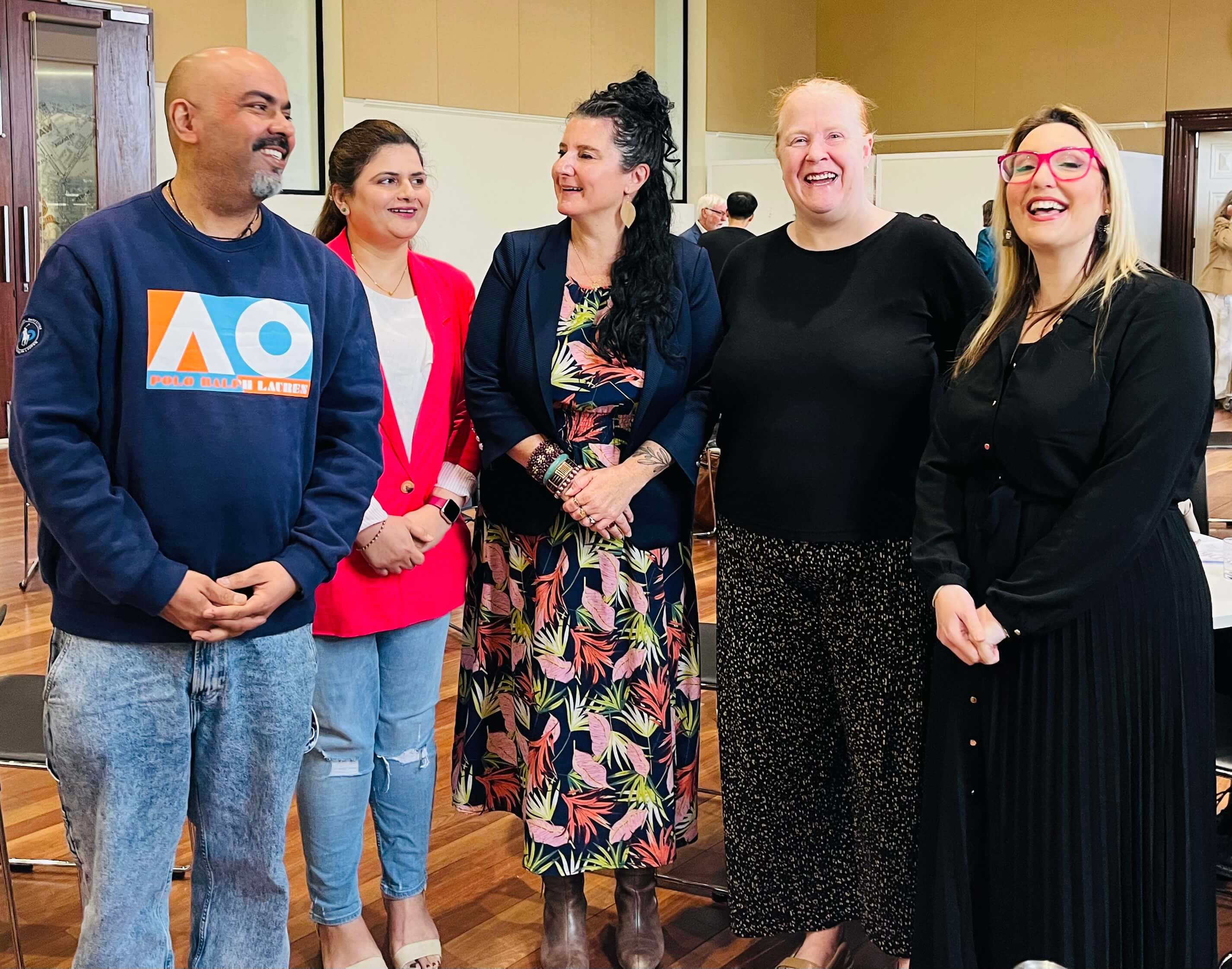 A group of five attendees smiling together at the MHCSA Annual AGM